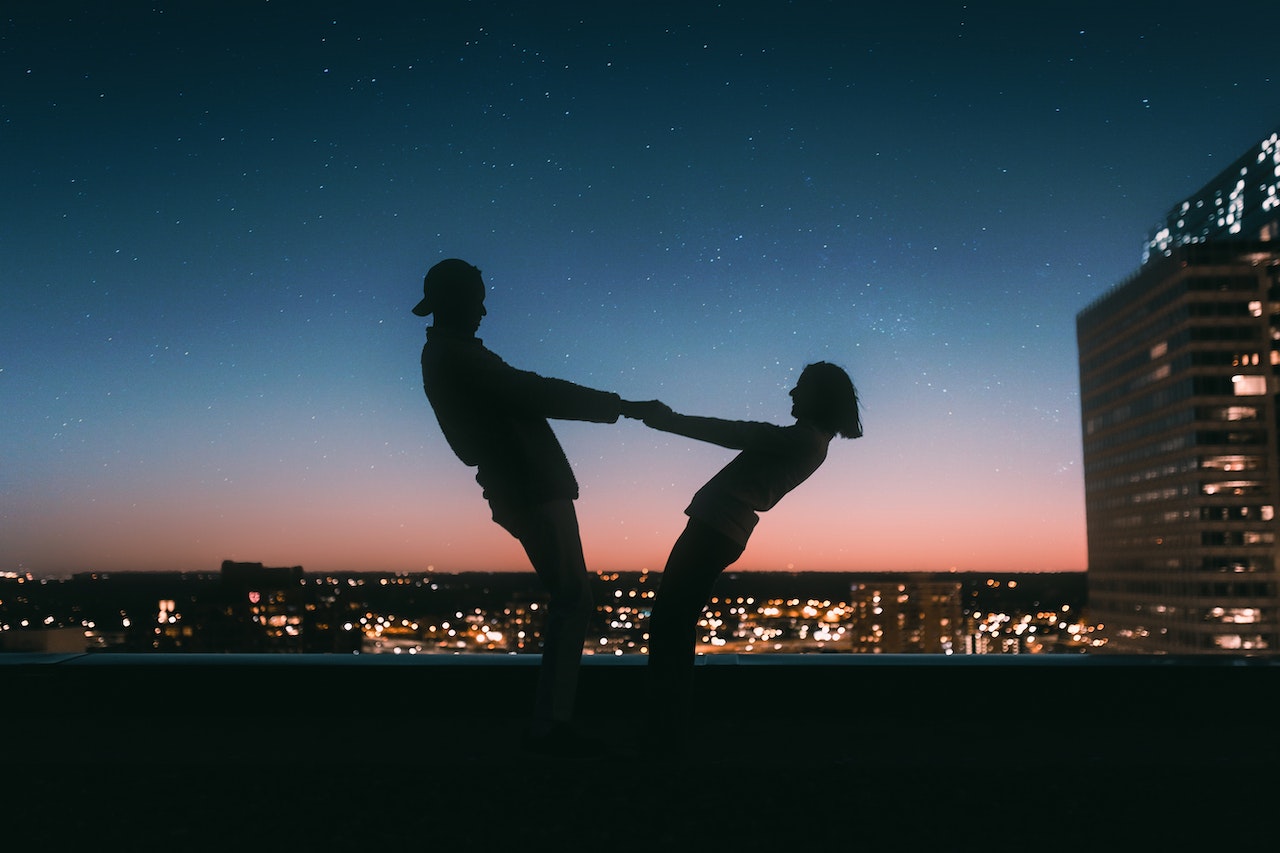 couple holding hands at sunset