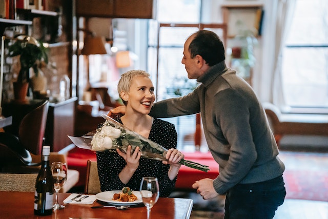 man gives his wife flowers